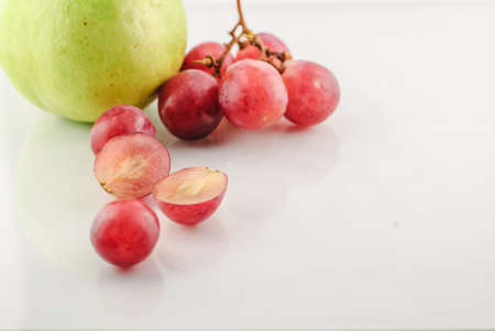 Close up red grape isolated on white backgroundの写真素材