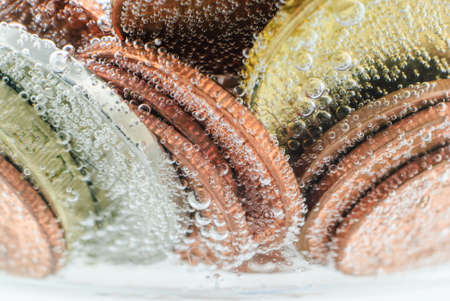 Old thai coin under water with small air bubblesの写真素材