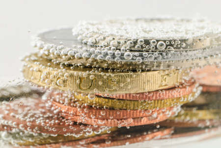 Old euro coin under water with small air bubblesの写真素材