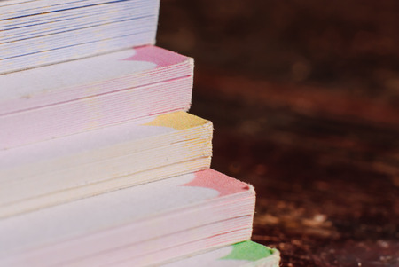 stack of books on the dark wood backgroundの写真素材