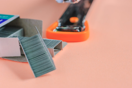 Staples and Stapler on red background isolatedの写真素材