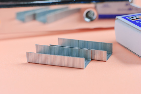 Staples and Stapler on red background isolatedの写真素材