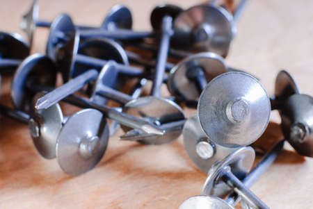 many metal nails close up macro on wooden