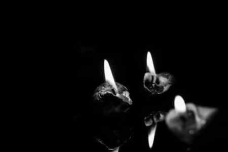 Candle on dark background. Light of candle.の写真素材