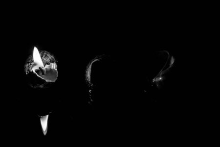 Candle on dark background. Light of candle.の写真素材