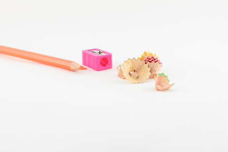 Colored pencil with colorful pencil shavings on white backgroundの写真素材