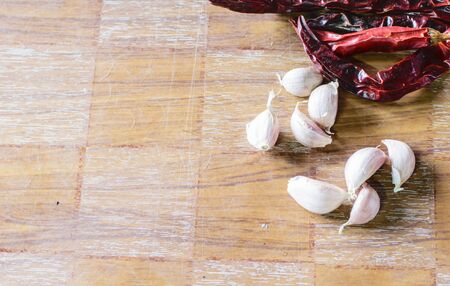 Several fresh garlic cloves on wood background.の写真素材