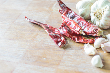 dried red chili peppers on dark backgroundの写真素材