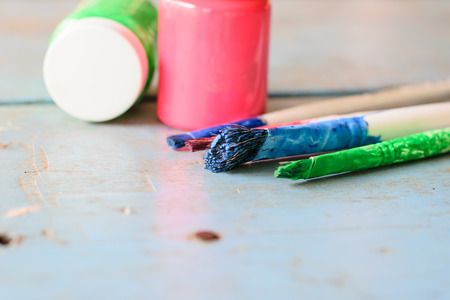 paints and brushes to paint laid on the table