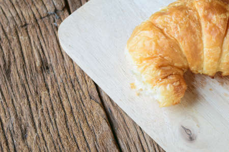 Fresh baked Croissants (close-up shot) on wooden backgroundの写真素材