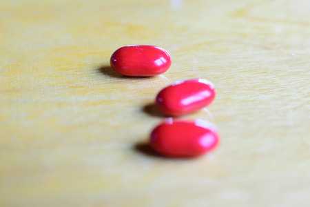 Red color pills close up macro photography