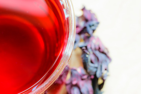 Closeup of roselle with drink over wooden surfaceの写真素材