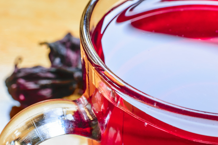 Closeup of roselle with drink over wooden surfaceの写真素材