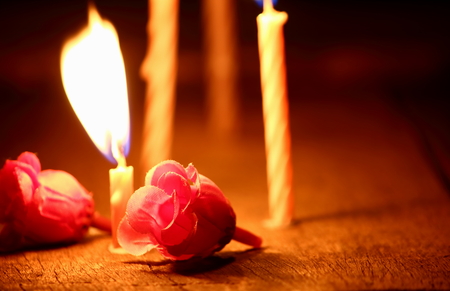 Burning candles with candle light in the darkの写真素材