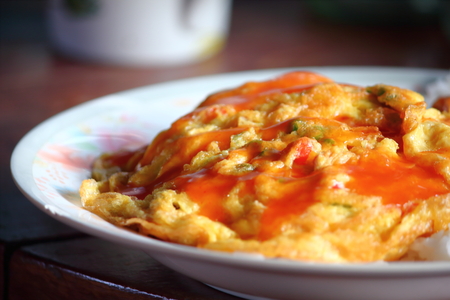 Thai style omelet on the plate with riceの写真素材