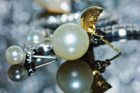 beautiful pearl earrings of woman in macro for backgroundの写真素材