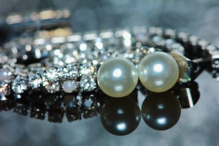 beautiful pearl earrings of woman in macro for backgroundの写真素材