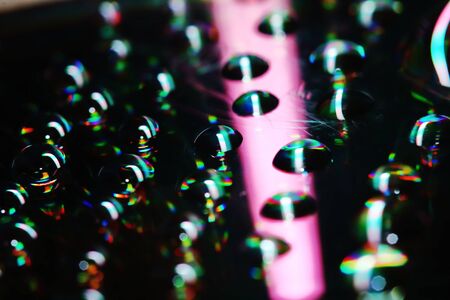 reflection of drop on cd in close up for beautiful light backgroundの写真素材