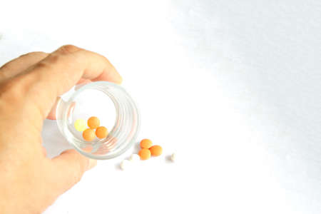a hands holding Medicine pills or capsules in box,Pharmaceutical medicament, cure in container for...