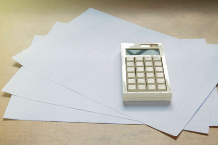 calculator with papel on office desk background