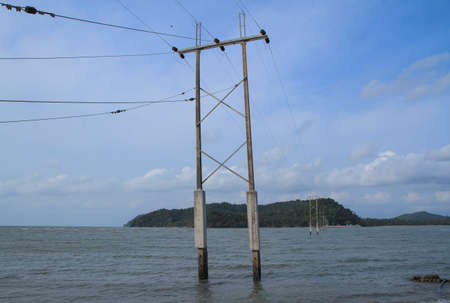 Electrical pole from shore to the islandの写真素材