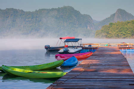 Foggy landscape with calm lake and pier.Mist over water. Beautiful freedom moment and peaceful...