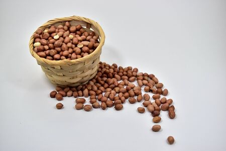 Peanuts in the basket on white background.の写真素材