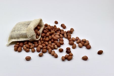 Peanuts in the cloth bags on white background.の写真素材