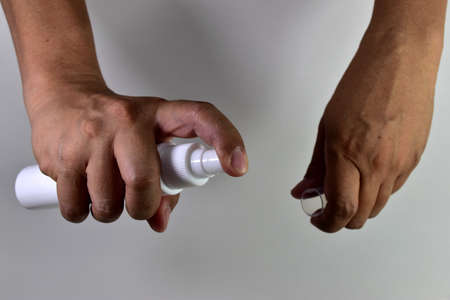 Man spray hand on white background.の写真素材