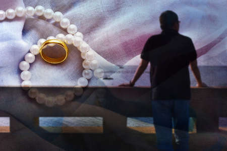 Blur background shadow rear of man the front is the sea and the sky thinking of something that is happy, Rings and marriages の写真素材