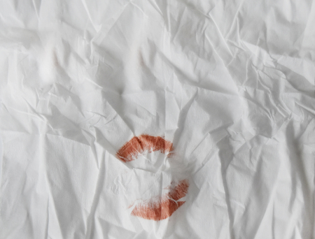 Red lipstick background on napkin and empty space for text.の写真素材