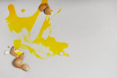 Cracked an egg on kitchen tile floor, Top view with copy spaceの写真素材