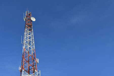Antenna tower at blue sky and white clouds on a beautiful day