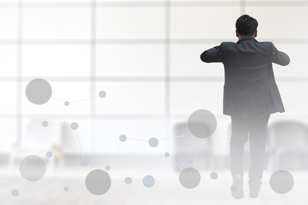 Young asia businessman smart wearing a suit,Turn around.
The concept of advancement of the new generation.
Can not see face and empty  left  space for text.  の写真素材