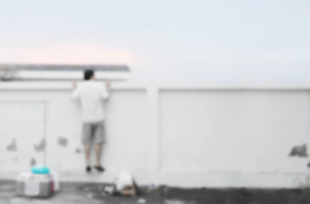 Background blur wide angle view, 
men wearing white shirts are facing the wall climb-up and empty space for text.の写真素材