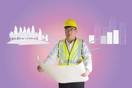 Asian construction engineer holding paper.
Forest and building are drawn doodle lines.
Concept of environmental balance and expansion of the city. Empty space for text.の写真素材