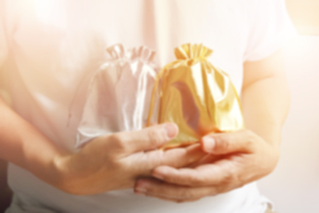 The background blurred a man wearing a white shirt and had a golden bag on his hand.の写真素材