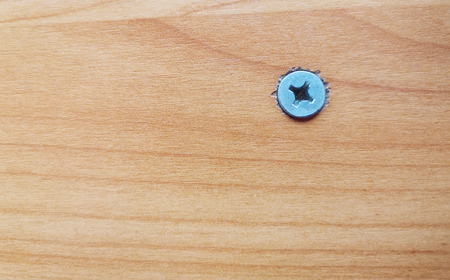 Top view of brown table with flat wood screws and empty space for text .の写真素材