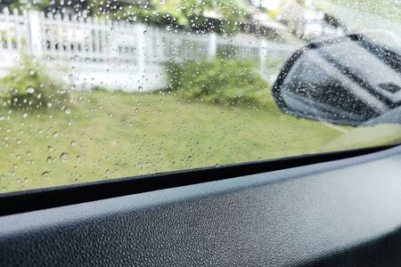 View through the sideview mirror ,roadside area On a rainy day, the weather is bad.の写真素材