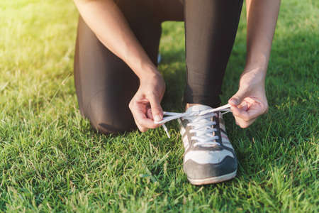 Exercise and healthy concept, young asian woman prepare shoe before running in the morning, selective focus.の写真素材