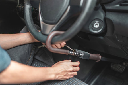 Close up of man use key locking steering wheel for security, Anti thief steal a car, Selective focus.の写真素材