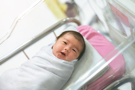 Asian newborn baby in  bassinet at delivery room at hospital.の写真素材