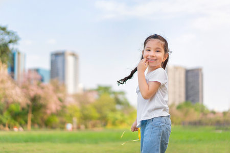 Happy cheerful caucasian mixed race girl smiling at outdoors park.の写真素材
