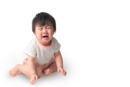 Asian baby girl close stare LED lamp with interest, low light situations.の写真素材