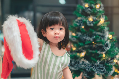 Happy asian mother and daughter decorating Christmas tree at home, Merry Christmas Eve and Happy New Year concept.の写真素材