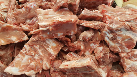 Raw fesh spare ribs on a wooden surface.Raw pork meat - spare ribs or belly. Fresh meat and ingredients. Butchery, market.の写真素材