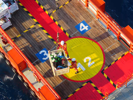 Supply boat transfer the cargo for supporting oil and gas industry and moving cargo from the boat to the platform. Boat is waiting transfer cargo and crews to platform.の写真素材