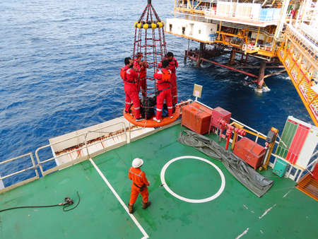 Workers are lifted by the crane to the offshore platform, Transfer crews by personal basket from the...