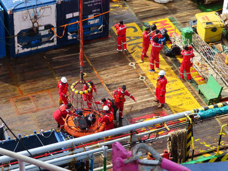 Workers are lifted by the crane to the offshore platform, Transfer crews by personal basket from the...
