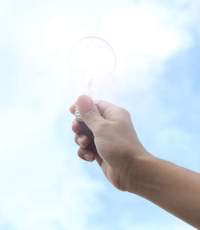Hand holding light bulbの写真素材